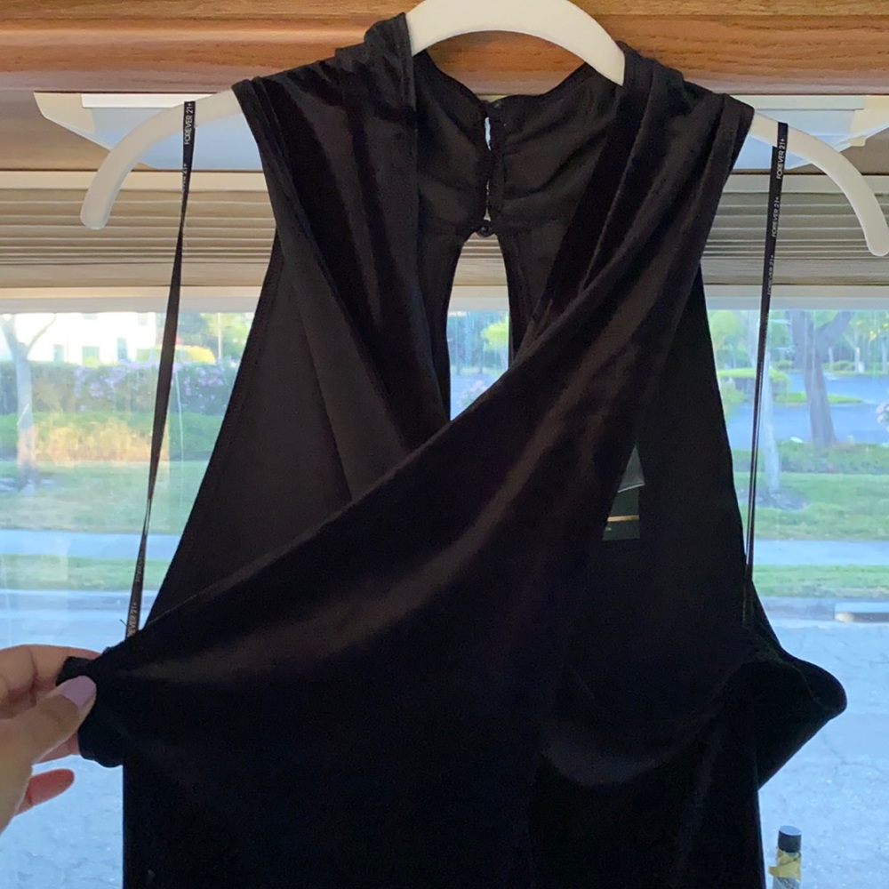 Black velvet romper with crisscross over chest.
